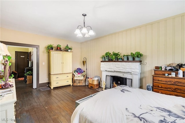 337 Youngstown Kingsville Rd SE, Vienna, OH 44473 - bedroom featuring dark wood-style floors, a fireplace, and a chandelier