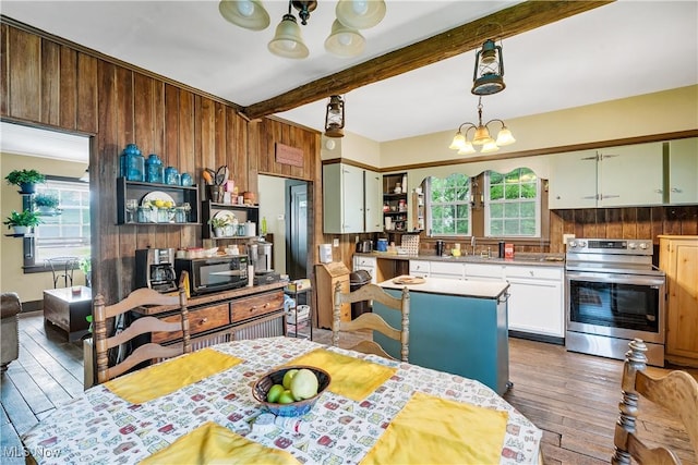337 Youngstown Kingsville Rd SE, Vienna, OH 44473 - kitchen with electric stove, black microwave, open shelves, plenty of natural light, and beamed ceiling