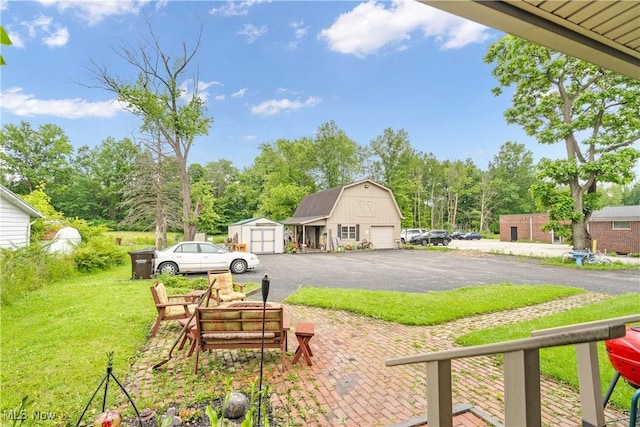 337 Youngstown Kingsville Rd SE, Vienna, OH 44473 - view of green lawn with a garage, a storage shed, and asphalt driveway