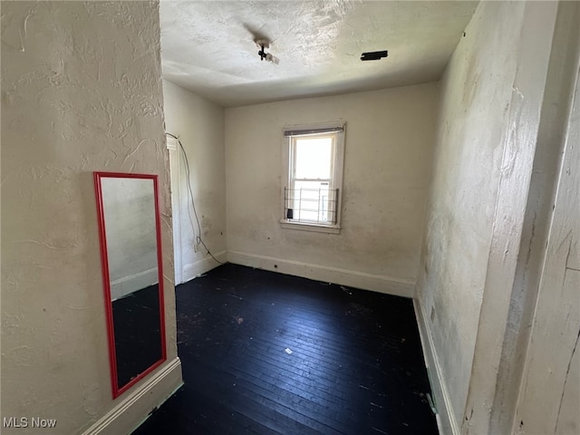 1185 E 74th St, Cleveland, OH 44103 - unfurnished room with hardwood / wood-style floors and a textured wall