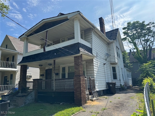 1185 E 74th St, Cleveland, OH 44103 - view of front of house featuring a porch and a chimney