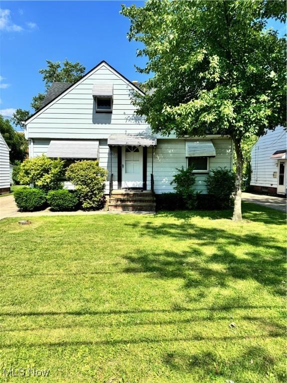 6033 E 135th St, Garfield Heights, OH 44125 - view of front facade with a front lawn