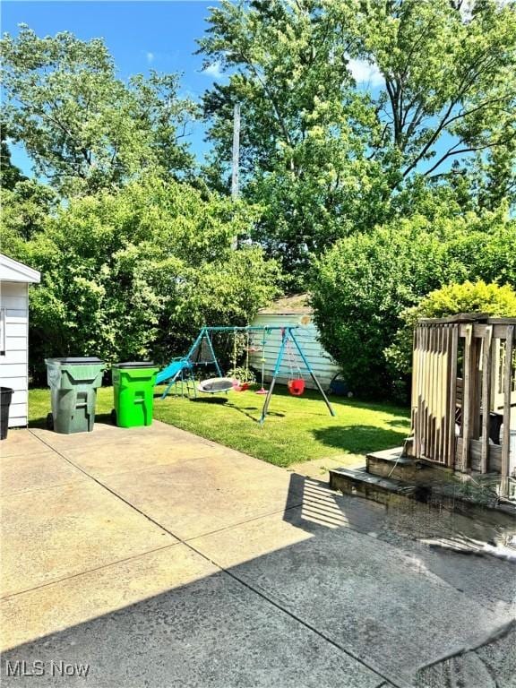 6033 E 135th St, Garfield Heights, OH 44125 - view of patio with a playground and view of scattered trees