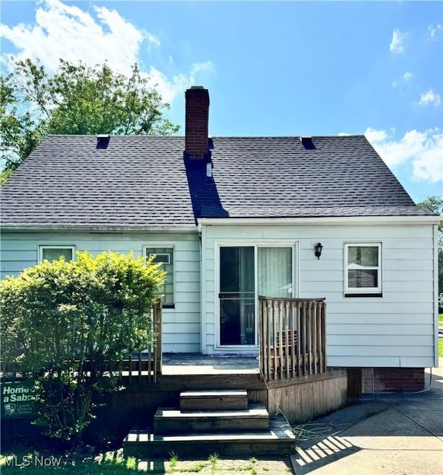 6033 E 135th St, Garfield Heights, OH 44125 - rear view of house with a chimney, a deck, and a shingled roof
