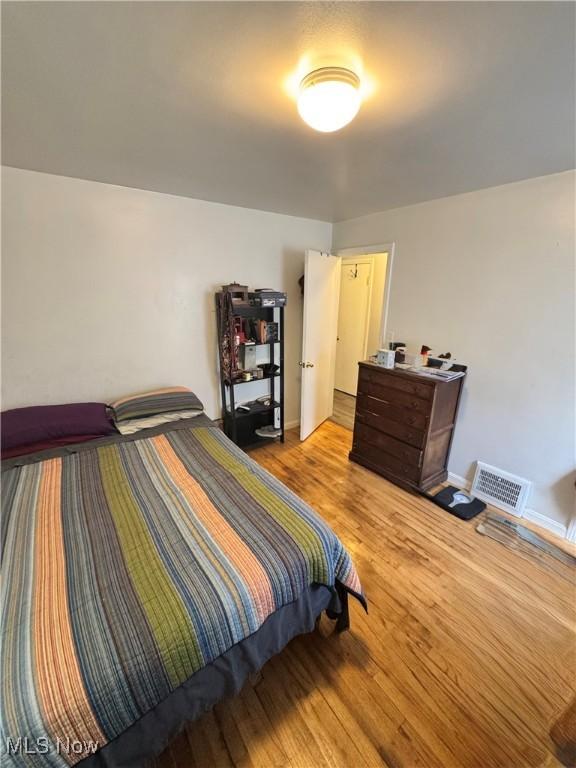 6033 E 135th St, Garfield Heights, OH 44125 - bedroom featuring wood finished floors and baseboards