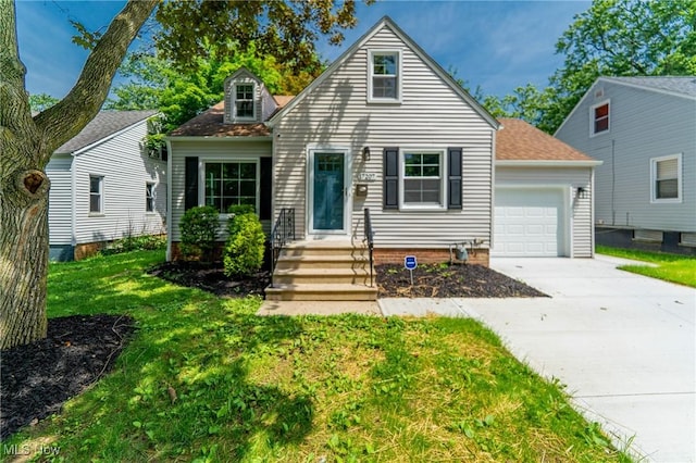17207 Maple Heights Blvd, Maple Heights, OH 44137 - cape cod-style house featuring concrete driveway, a front yard, roof with shingles, and an attached garage