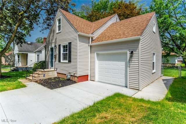 17207 Maple Heights Blvd, Maple Heights, OH 44137 - view of front of home with an attached garage, concrete driveway, and roof with shingles