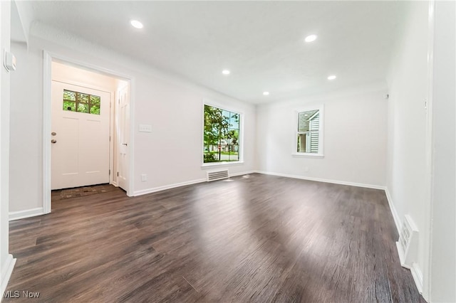 17207 Maple Heights Blvd, Maple Heights, OH 44137 - unfurnished living room featuring dark wood-style flooring and recessed lighting