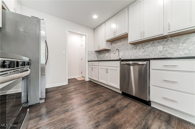17207 Maple Heights Blvd, Maple Heights, OH 44137 - kitchen featuring appliances with stainless steel finishes, dark countertops, dark wood-type flooring, decorative backsplash, and recessed lighting