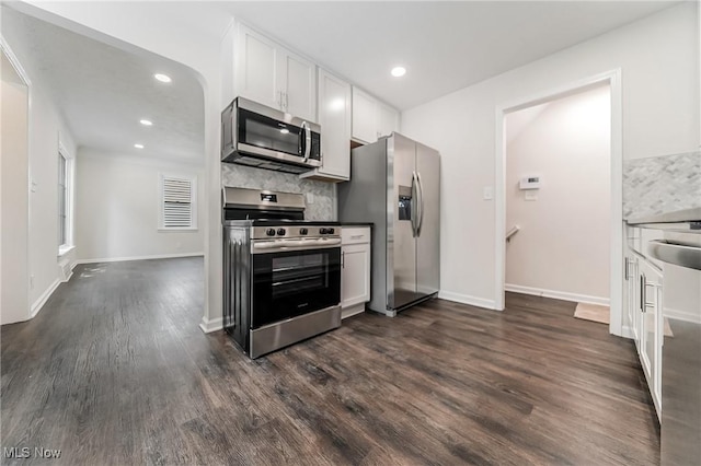 17207 Maple Heights Blvd, Maple Heights, OH 44137 - kitchen featuring appliances with stainless steel finishes, dark wood-type flooring, white cabinets, tasteful backsplash, and recessed lighting