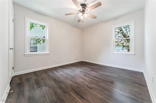 17207 Maple Heights Blvd, Maple Heights, OH 44137 - spare room with healthy amount of natural light, dark wood-type flooring, and ceiling fan