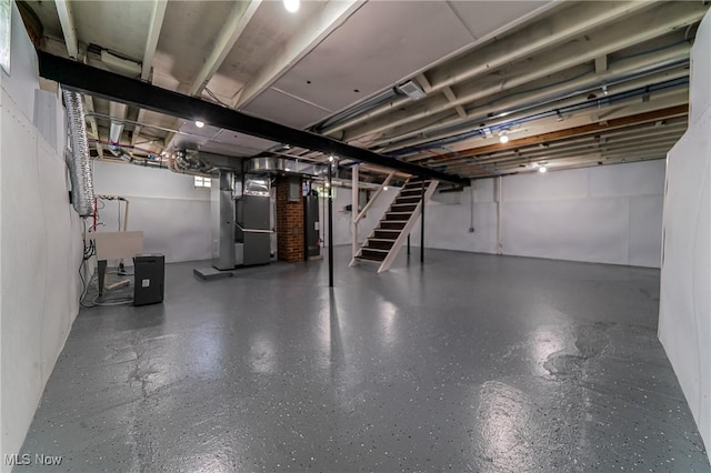 17207 Maple Heights Blvd, Maple Heights, OH 44137 - unfinished below grade area with heating unit, stairway, and gas water heater