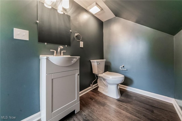17207 Maple Heights Blvd, Maple Heights, OH 44137 - half bathroom featuring vanity, wood finished floors, and lofted ceiling