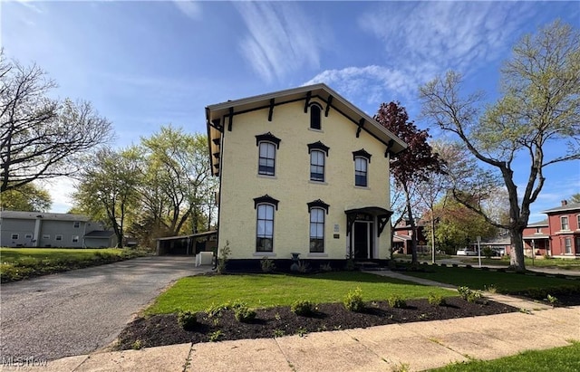203 W 6th St, Dover, OH 44622 - italianate home featuring a front yard and a carport