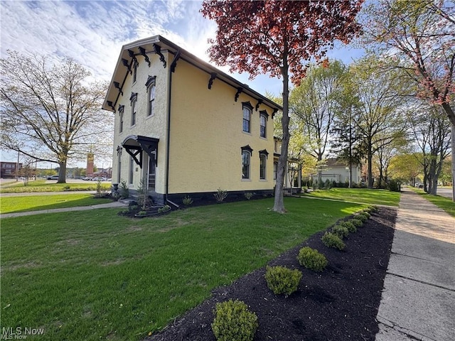 203 W 6th St, Dover, OH 44622 - view of side of property featuring stucco siding and a yard
