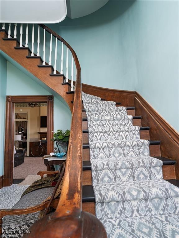 203 W 6th St, Dover, OH 44622 - stairs featuring wainscoting and carpet floors