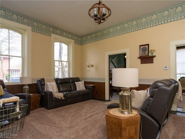 203 W 6th St, Dover, OH 44622 - living area featuring a wainscoted wall, carpet floors, and a chandelier