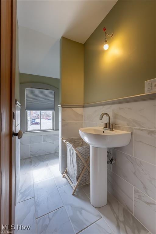 203 W 6th St, Dover, OH 44622 - bathroom with tile walls, marble finish flooring, lofted ceiling, and wainscoting