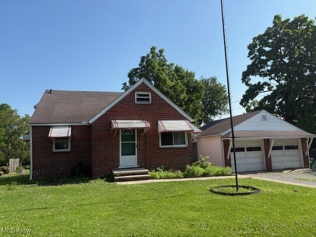 15920 Grove St, Middlefield, OH 44062 - view of front facade with brick siding, a front lawn, a detached garage, and driveway