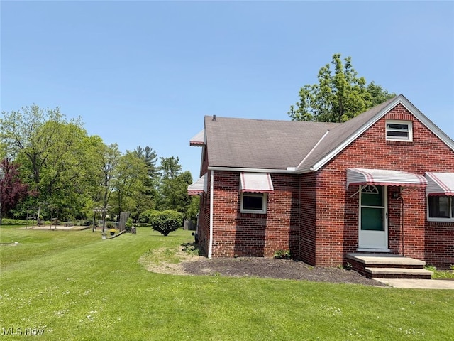 15920 Grove St, Middlefield, OH 44062 - view of front of property with brick siding, a front lawn, and a shingled roof