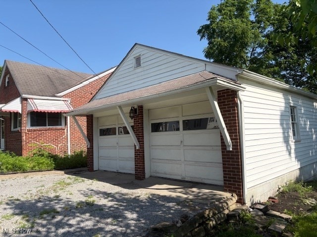 15920 Grove St, Middlefield, OH 44062 - view of property exterior with brick siding, a garage, and asphalt driveway