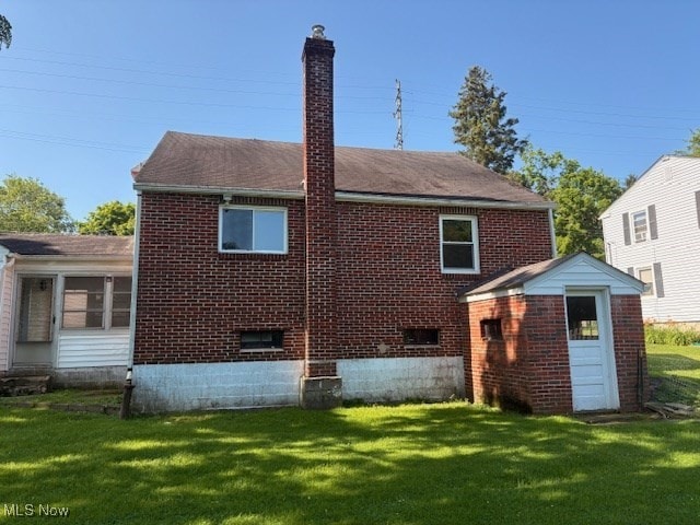 15920 Grove St, Middlefield, OH 44062 - back of house with a chimney, a yard, brick siding, a storage unit, and a shingled roof