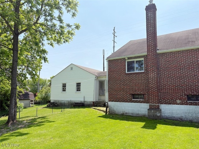 15920 Grove St, Middlefield, OH 44062 - back of house with a chimney, brick siding, and a shingled roof