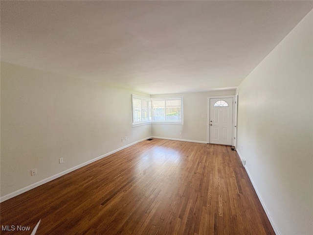 15920 Grove St, Middlefield, OH 44062 - unfurnished living room with wood finished floors and baseboards