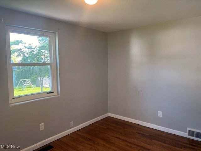 15920 Grove St, Middlefield, OH 44062 - spare room featuring baseboards and dark wood-style flooring