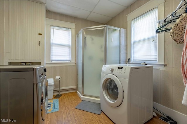 337 Garfield Ave NW, Carrollton, OH 44615 - laundry room with light wood-style floors, healthy amount of natural light, and washer and clothes dryer
