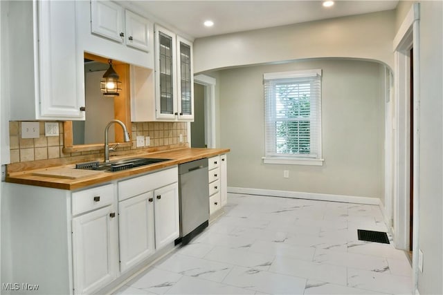 400 Spring St, Struthers, OH 44471 - kitchen with butcher block counters, dishwasher, glass insert cabinets, light marble finish floors, and recessed lighting