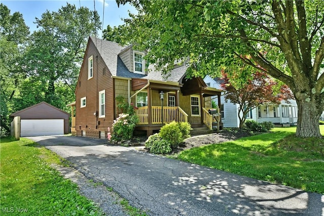 400 Spring St, Struthers, OH 44471 - view of front of home with a porch, an outbuilding, a detached garage, and a front lawn