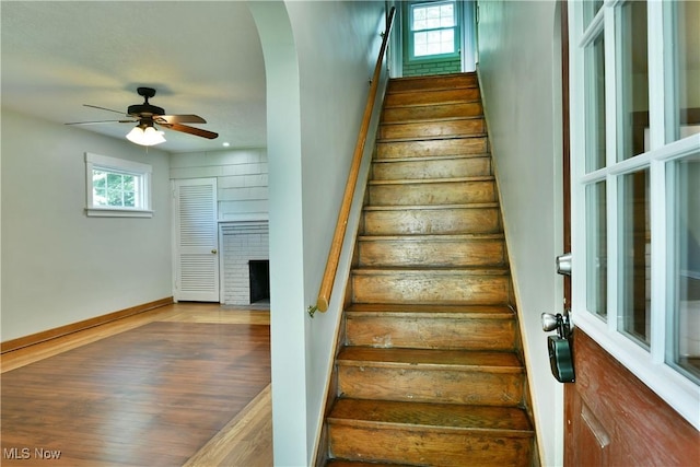 400 Spring St, Struthers, OH 44471 - staircase with plenty of natural light, arched walkways, wood finished floors, and a ceiling fan