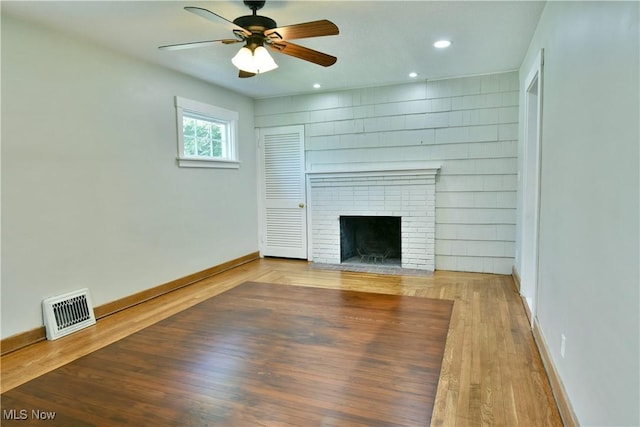 400 Spring St, Struthers, OH 44471 - unfurnished living room with a fireplace, a ceiling fan, wood finished floors, and recessed lighting