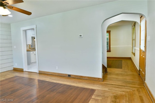 400 Spring St, Struthers, OH 44471 - unfurnished room featuring ceiling fan, arched walkways, and parquet flooring