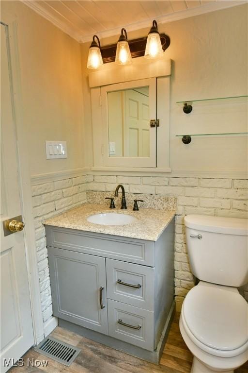 400 Spring St, Struthers, OH 44471 - half bath with ornamental molding, vanity, wood finished floors, and wainscoting