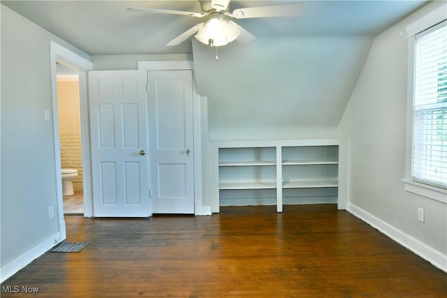 400 Spring St, Struthers, OH 44471 - unfurnished bedroom featuring wood finished floors, multiple windows, vaulted ceiling, and a ceiling fan