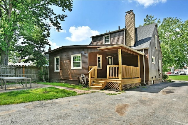 400 Spring St, Struthers, OH 44471 - view of front of home with a chimney, covered porch, and roof with shingles