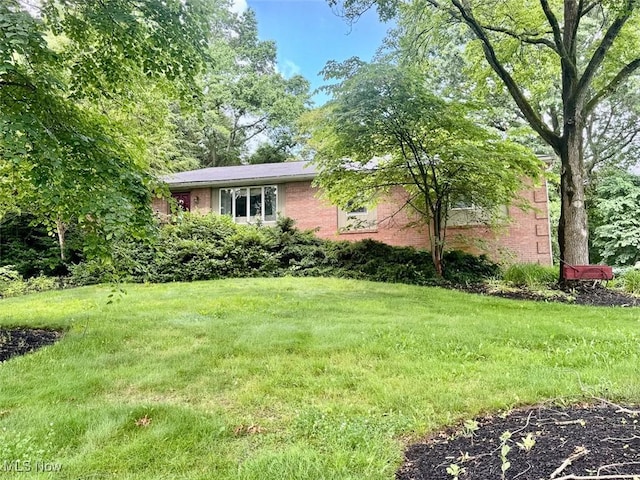 7621 Sandpiper Ave NW, North Canton, OH 44720 - view of front facade featuring brick siding and a front lawn