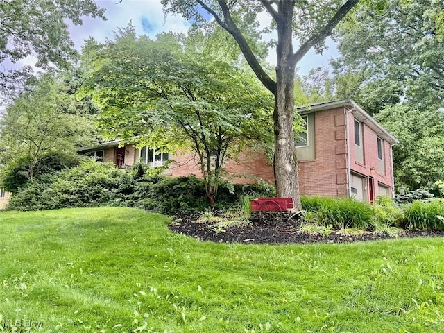 7621 Sandpiper Ave NW, North Canton, OH 44720 - view of side of home with brick siding and a lawn