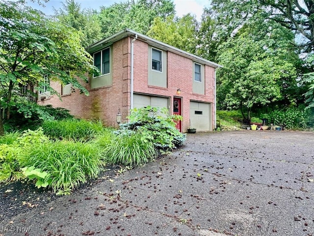 7621 Sandpiper Ave NW, North Canton, OH 44720 - view of front facade with a garage, asphalt driveway, and brick siding