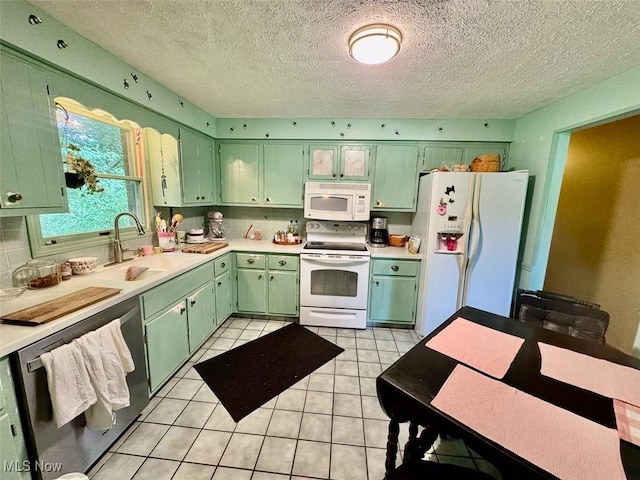 7621 Sandpiper Ave NW, North Canton, OH 44720 - kitchen featuring white appliances, green cabinets, light countertops, backsplash, and a textured ceiling