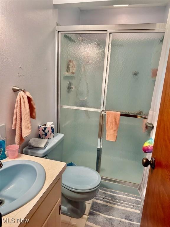 7621 Sandpiper Ave NW, North Canton, OH 44720 - bathroom featuring vanity, a stall shower, and tile patterned flooring