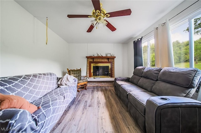 5251 Sugar Grove Rd, Cambridge, OH 43725 - living area with plenty of natural light, wood finished floors, a ceiling fan, and a brick fireplace