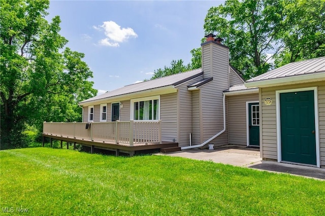 5251 Sugar Grove Rd, Cambridge, OH 43725 - back of property featuring a wooden deck, a yard, a chimney, a metal roof, and a patio area