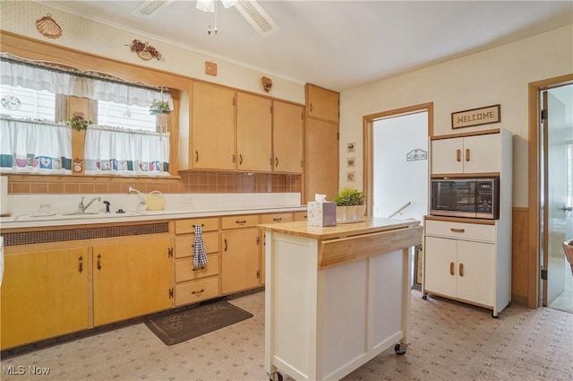 715 E Lincoln Way, Lisbon, OH 44432 - kitchen with black microwave, light floors, ceiling fan, and backsplash