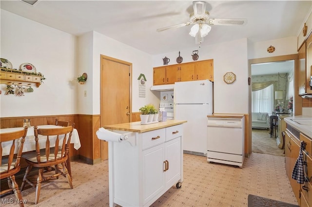 715 E Lincoln Way, Lisbon, OH 44432 - kitchen with freestanding refrigerator, light countertops, a wainscoted wall, ceiling fan, and a kitchen island