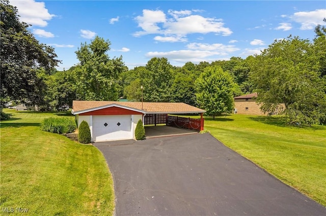 715 E Lincoln Way, Lisbon, OH 44432 - view of front of home with a front yard, driveway, and a detached garage