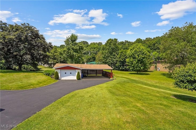 715 E Lincoln Way, Lisbon, OH 44432 - view of front of house featuring a front lawn, a carport, and asphalt driveway
