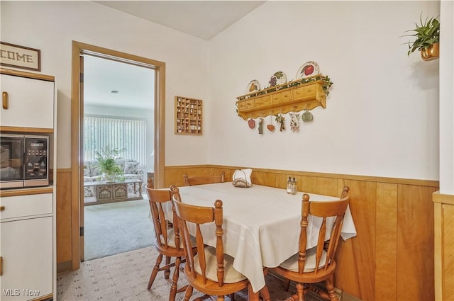 715 E Lincoln Way, Lisbon, OH 44432 - carpeted dining area featuring a wainscoted wall and wood walls